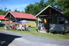 Cabins at Skærbæk Camping with outdoor communal dining.